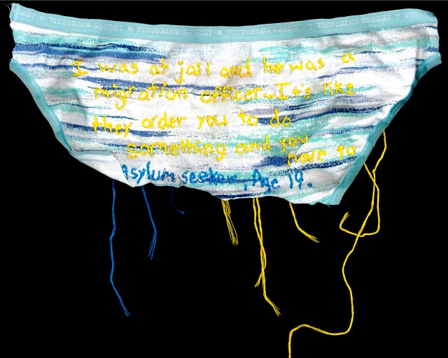 A pair of aqua, grey and white underwear are embroidered with the quote using yellow and blue thread
